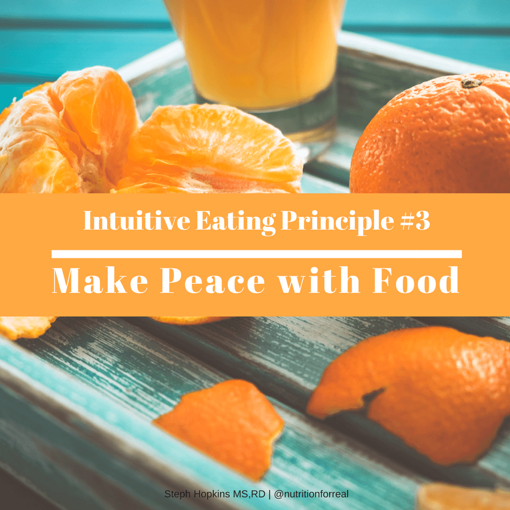 Peeled oranges and clementines on a weathered teal wood surface.