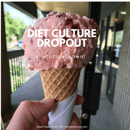 A hand holding a waffle cone with a scoop of berry ice cream outside on a sunny day.
