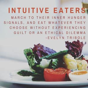 A bright mixed greens salad with tomatoes, sliced egg, and potatoes.